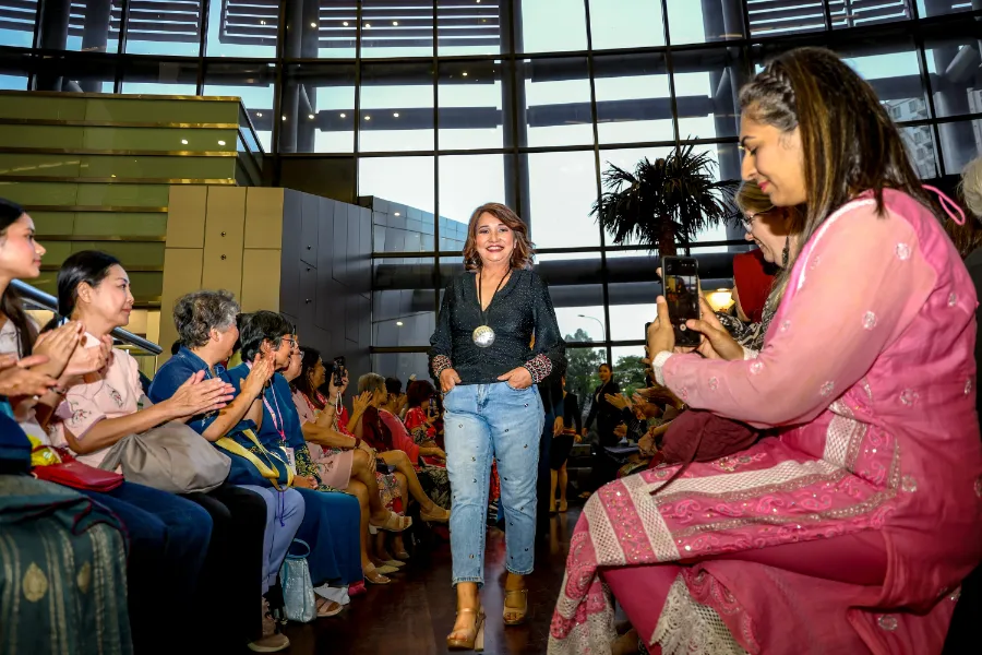 Susan Foong, a 14-year breast cancer survivor, received loud cheers from the crowd when she took the runway.jpg Susan Foong, a 14-year breast cancer survivor, received loud cheers from the crowd when she took the runway.jpg
